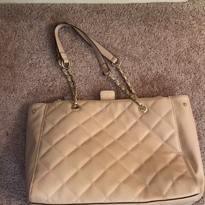 Cream colored quilted bag.
